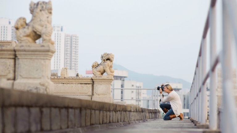 SCAD student taking photos on field trip to cemetery