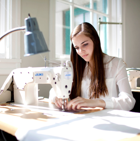 Fashion student learning sewing skills in Eckburg Hall